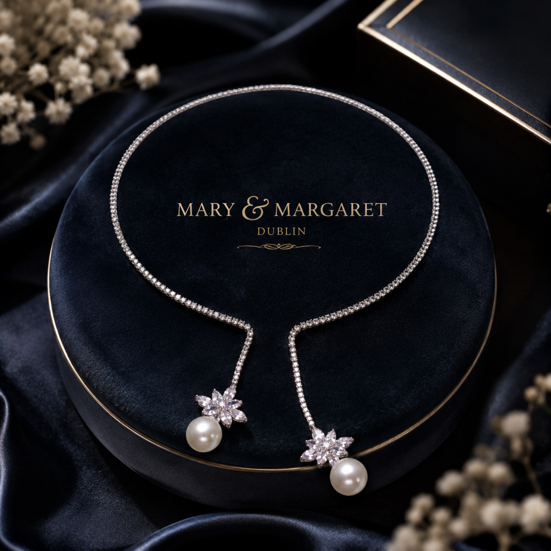 Silver-tone pearl drop necklace with two star pendants and pavé link chain