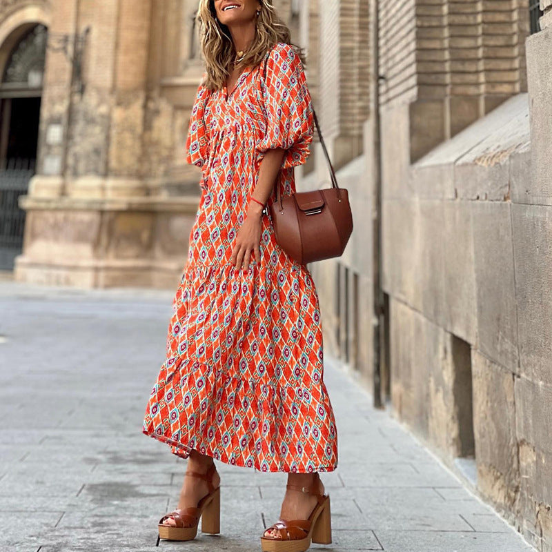 Red patterned v-neck midi dress with puff sleeves and tiered skirt