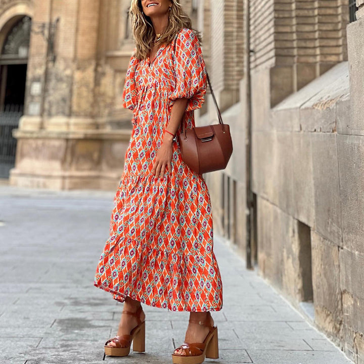 Red patterned v-neck midi dress with puff sleeves and tiered skirt